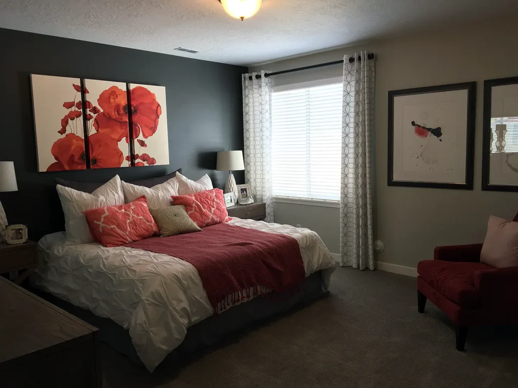 Finished basement bedroom with window, accent wall, and modern finishes.