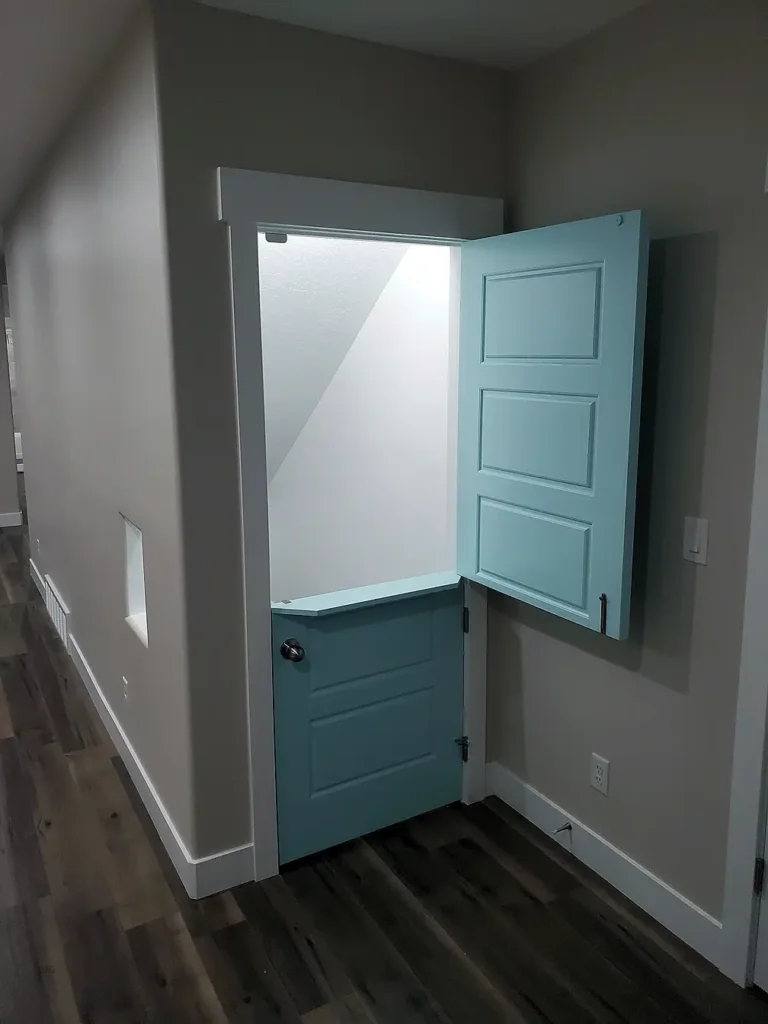 Syracuse Utah Basement Finishing with and under the stairs playroom with a custom door