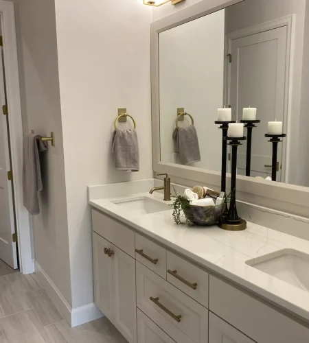 finished basement bathroom with double vanity and modern lighting