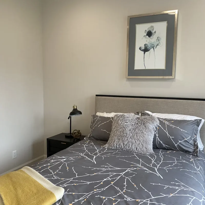 Basement Finishing Utah- basement bedroom with a large bed