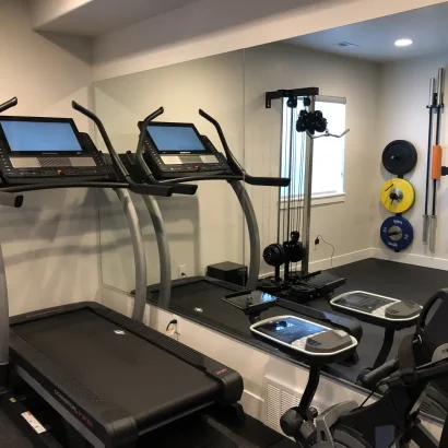 Basement Finishing Utah- a custom home gym with lots of free weights and other equipment