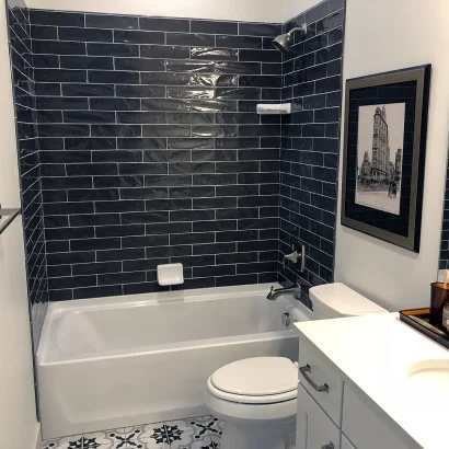 Basement Finishing Utah- bathroom with a black tile surround