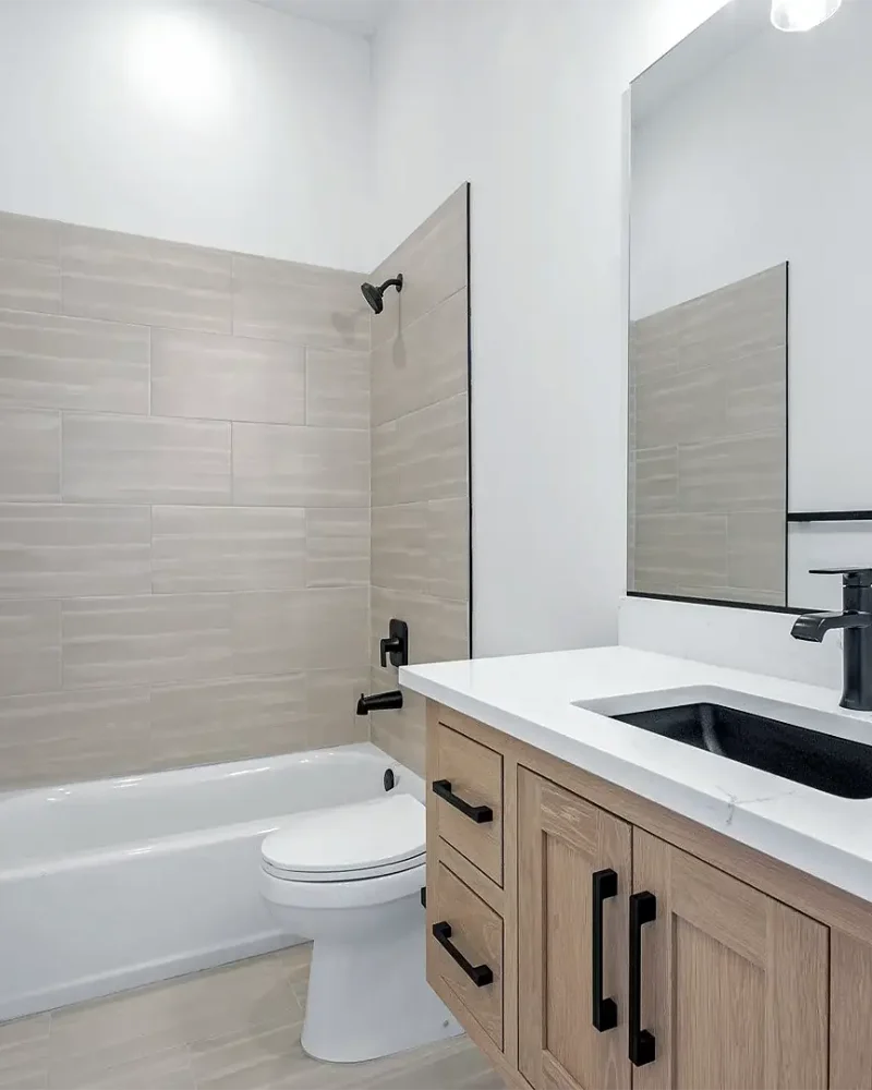 Syracuse Utah Basement Bathroom with a tile surround and a custom vanity