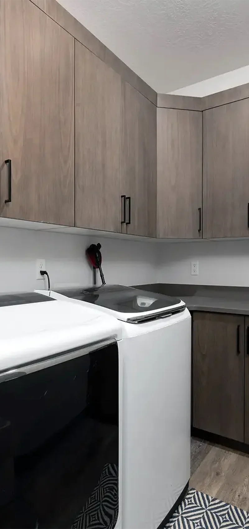 Saratoga Springs Basement Finishing- custom laundry room with cabinets