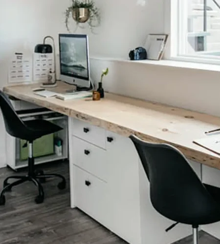 Built-in basement office desk with storage drawers and dual workspace setup