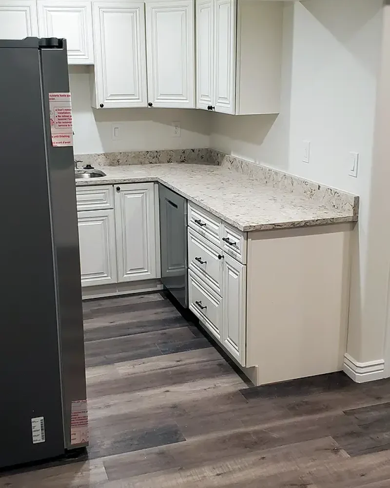 Basement Finishing Utah- a fully setup kitchenette with a full sized refrigerator