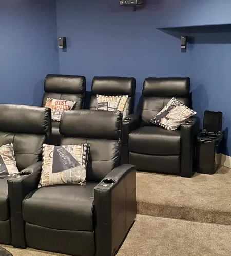 Basement Finishing Utah- a basement theater room with comfortable chairs