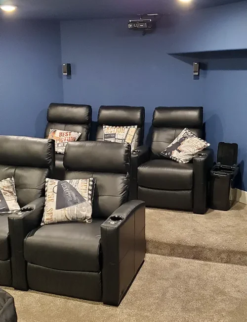 Basement Finishing Utah- a basement theater room with comfortable chairs