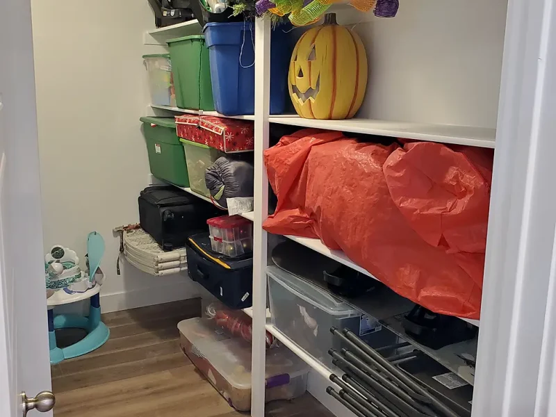 basement storage room with shelving and storage bins
