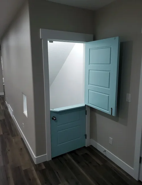 Syracuse Utah Basement Finishing with and under the stairs playroom with a custom door