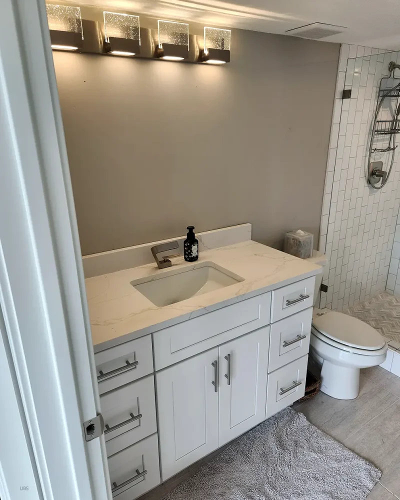 Basement Finishing Utah- a basement bathroom with a standard white vanity
