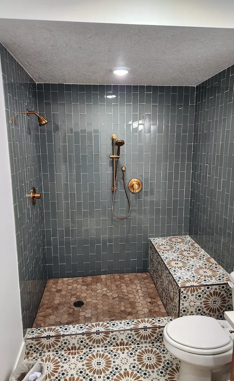 Basement Finishing Utah featuring a custom shower with tile work and a Euro Glass door