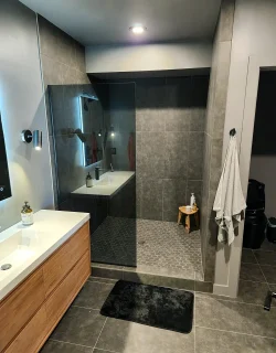 Basement finishing Utah- custom bathroom with a tile shower and a glass door