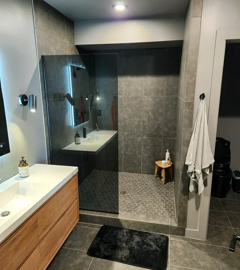 Basement finishing Utah- custom bathroom with a tile shower and a glass door