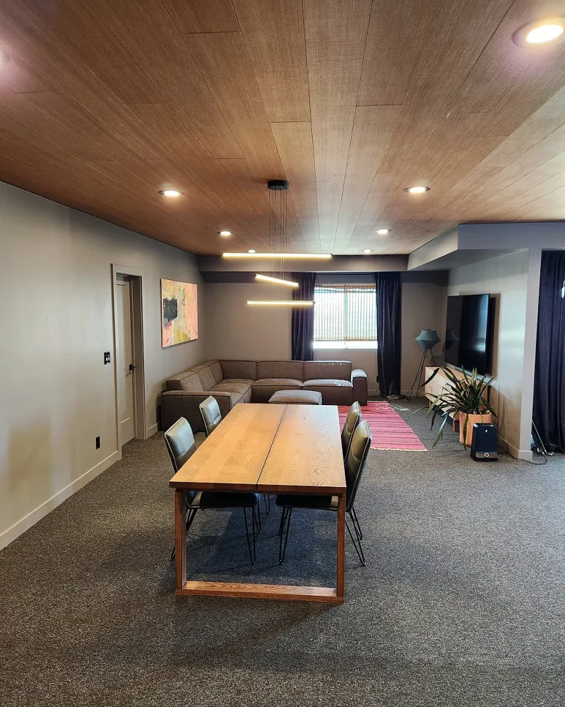 Basement Finishing Utah- a great family room with lots of space for a game table, TV, and comfortable chairs seating