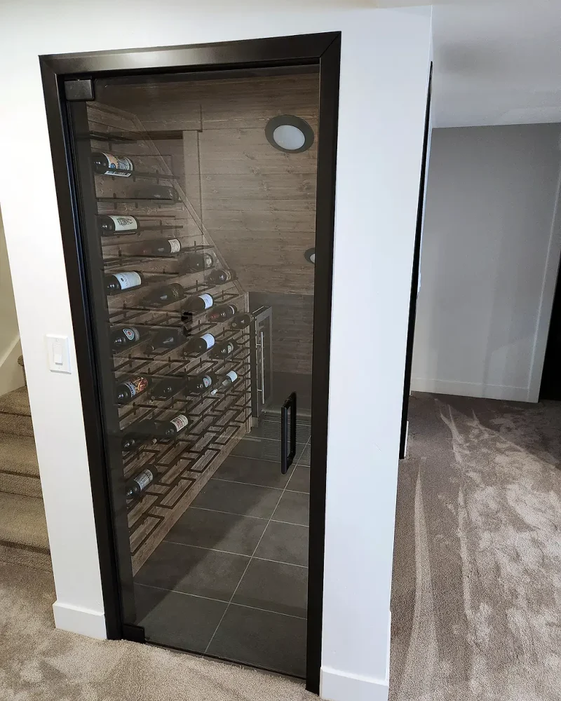 Basement Finishing Utah- a basement wine rack in a separate room with glass panels