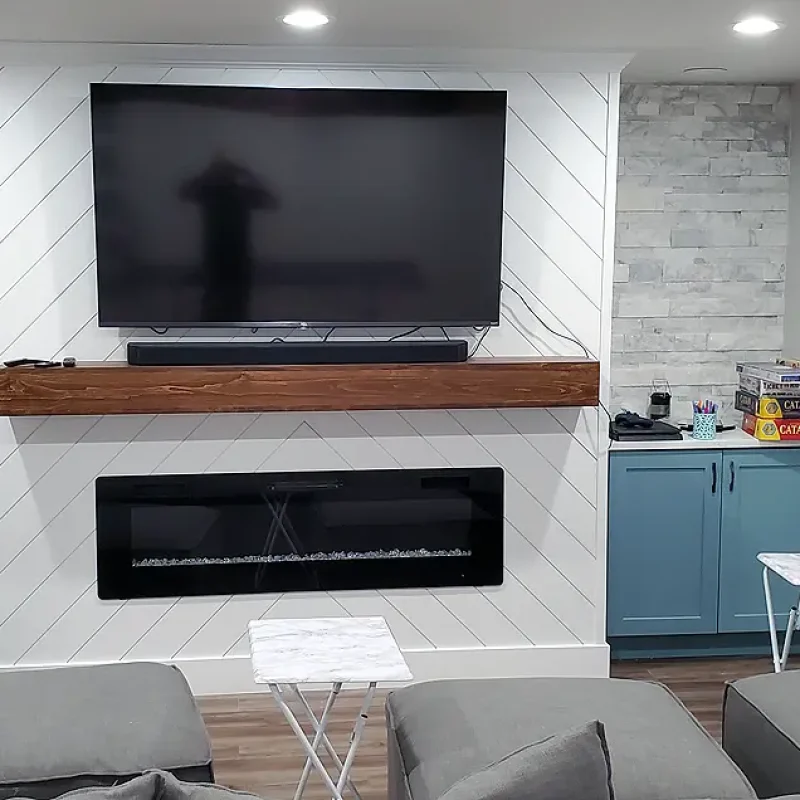 Basement Finishing Utah- Basement family room with custom built ins for a TV and firepalce