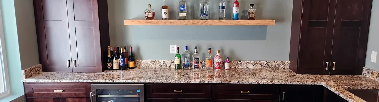 Basement Finishing Utah- wet bar with wood cabinets and granite countertops