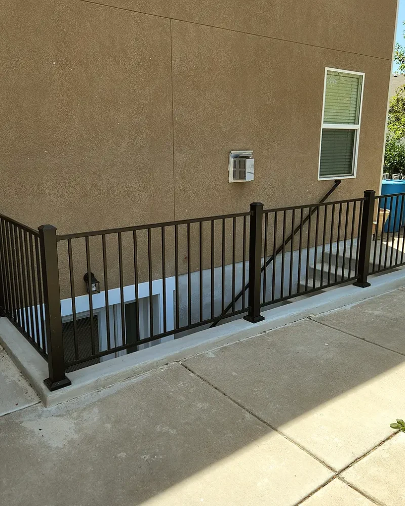 Utah Basement Finishing- an exterior entrance with a black safety railing