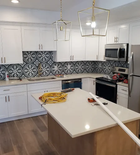 Utah Basement Finishing- basement kitchen with white cabinets and an island