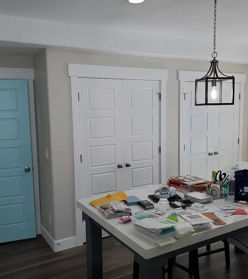 basement craft room with large work table and built in storage