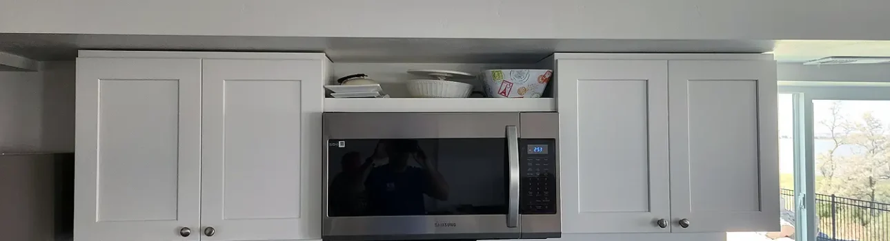 Utah Basement Finishing- a kitchenette in the basement with a a microwave oven and granite countertops